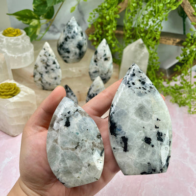 Moonstone Freeform Cut Base - By Weight both variants in hand for size reference with other moonstone cutbases in background