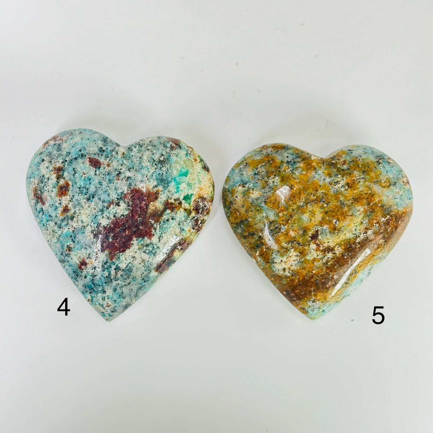 amazonite heart with decorations in the background