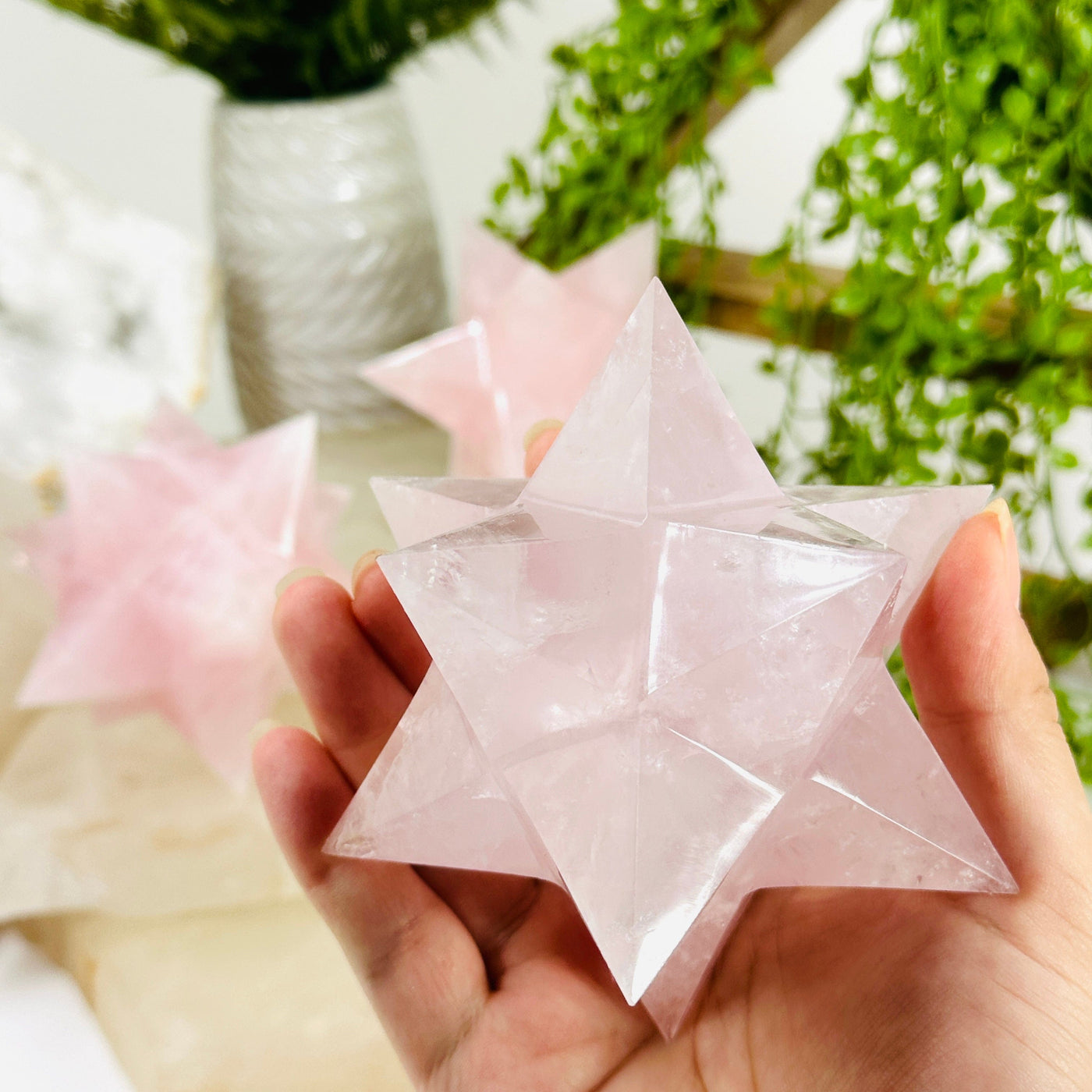 Rose Quartz Merkaba - You Choose variant B in hand for size reference with other variants in background