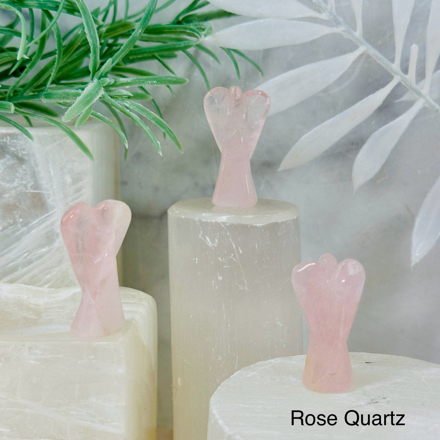 Gemstone Angels - Medium 3 rose quartz angels on pedestals at different angles labeled