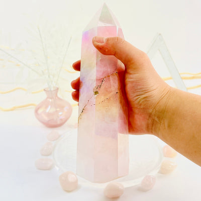 Angel Aura Rose Quartz Tower with Natural Inclusions in hand for size reference
