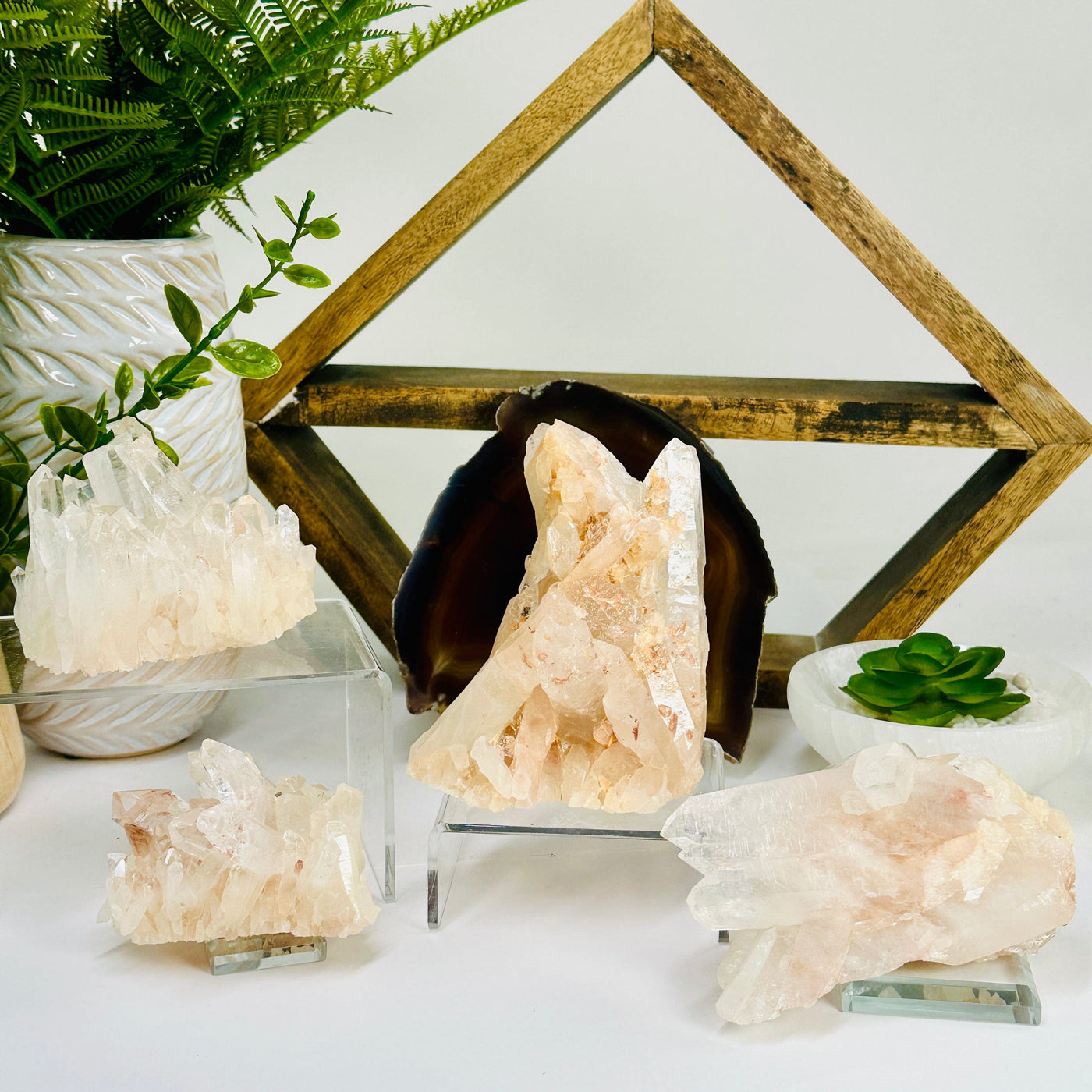 Lemurian Tangerine Quartz Crystal Cluster - You Choose all clusters arranged on different stands with props in background