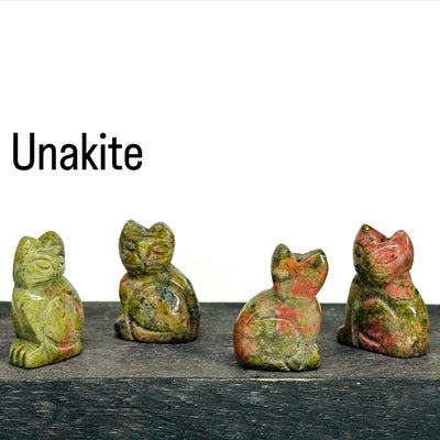 Unakite Gemstone Cats on a wood shelf.