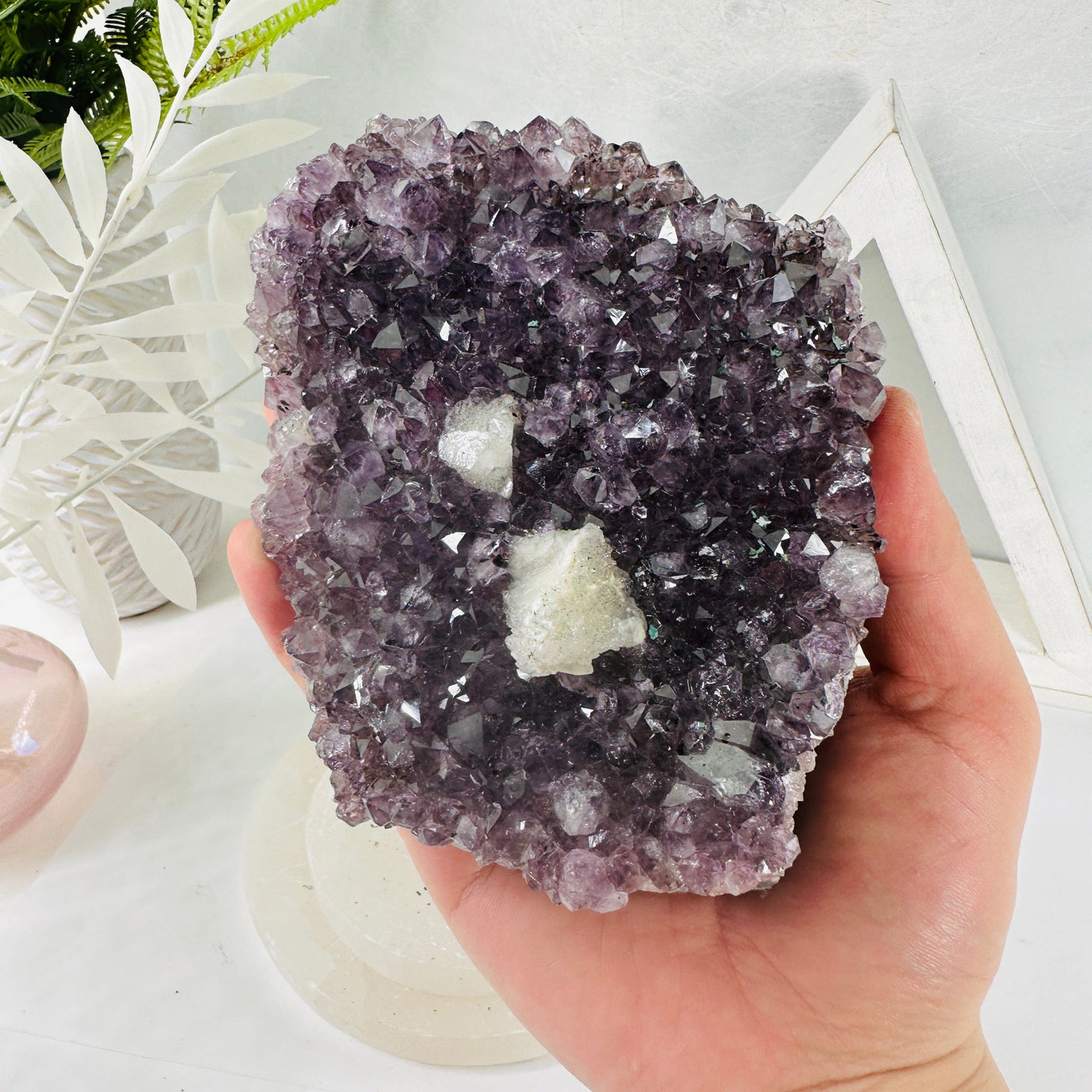 Amethyst Crystal Cluster - amethyst rough stone in hand for size reference