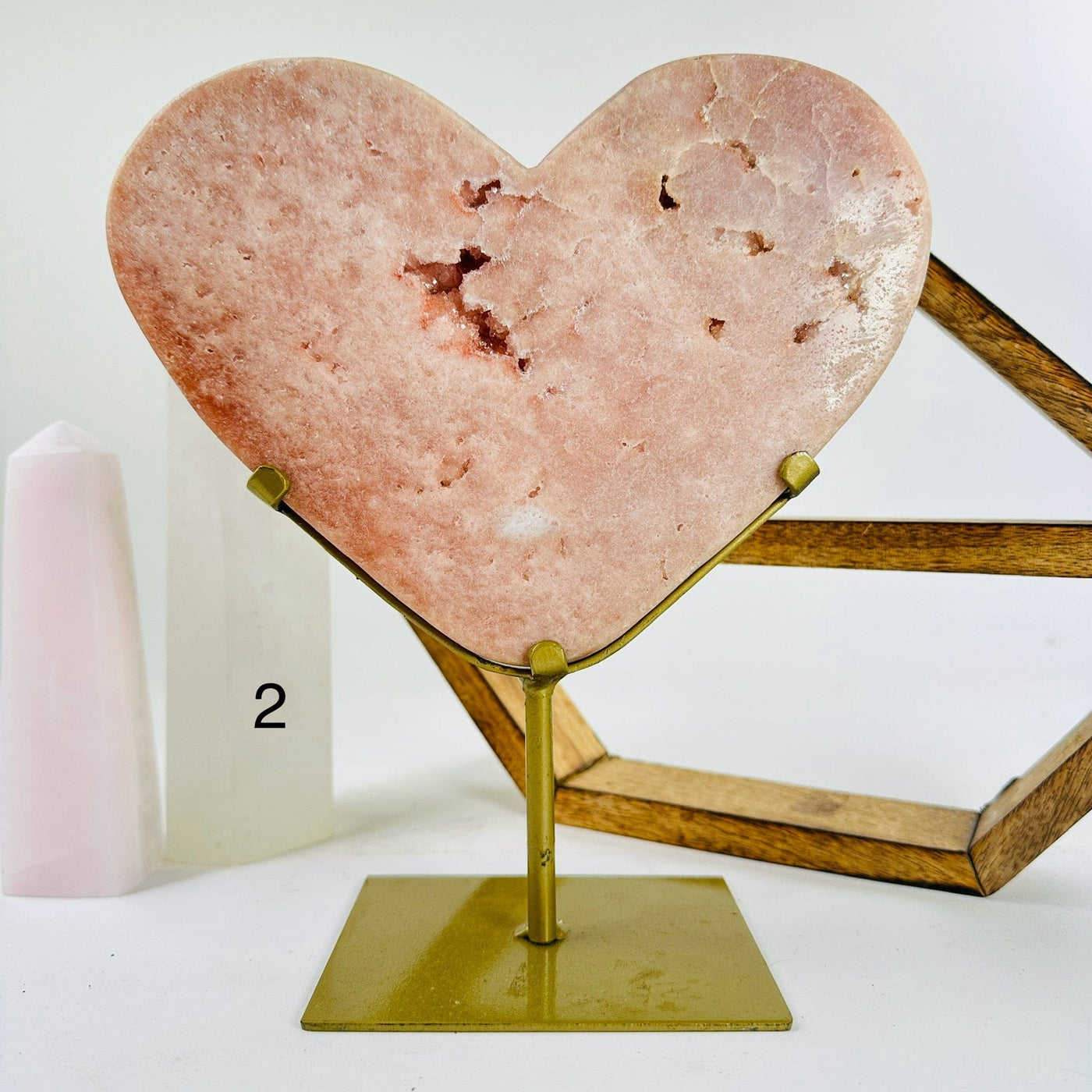 pink amethyst hearts on metal stand with decorations in the background