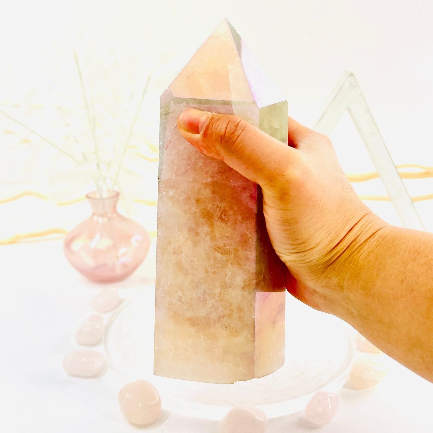 Angel Aura Rose Quartz Polished Point with Natural Inclusions in hand for size reference