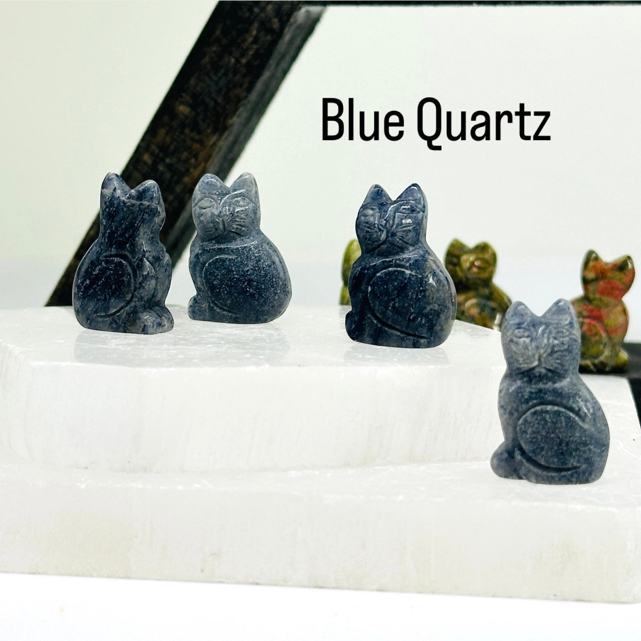 Blue quartz Gemstone Cats on selenite slabs.