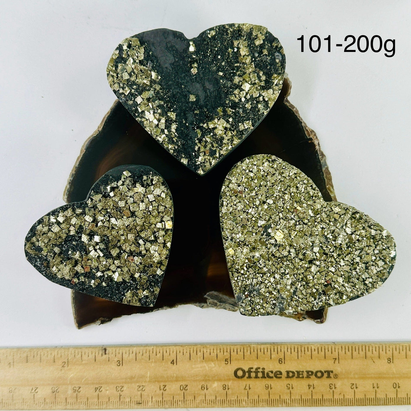 Pyrite on Basalt Hearts - By Weight 101-200g variants on dark agate slice with ruler for size reference