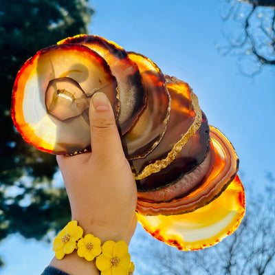 Agate Slice Set - Set of Eight Agate Crystal Coasters all coasters in hand for size reference