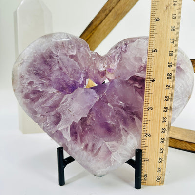 amethyst heart with stand next to a ruler for size reference