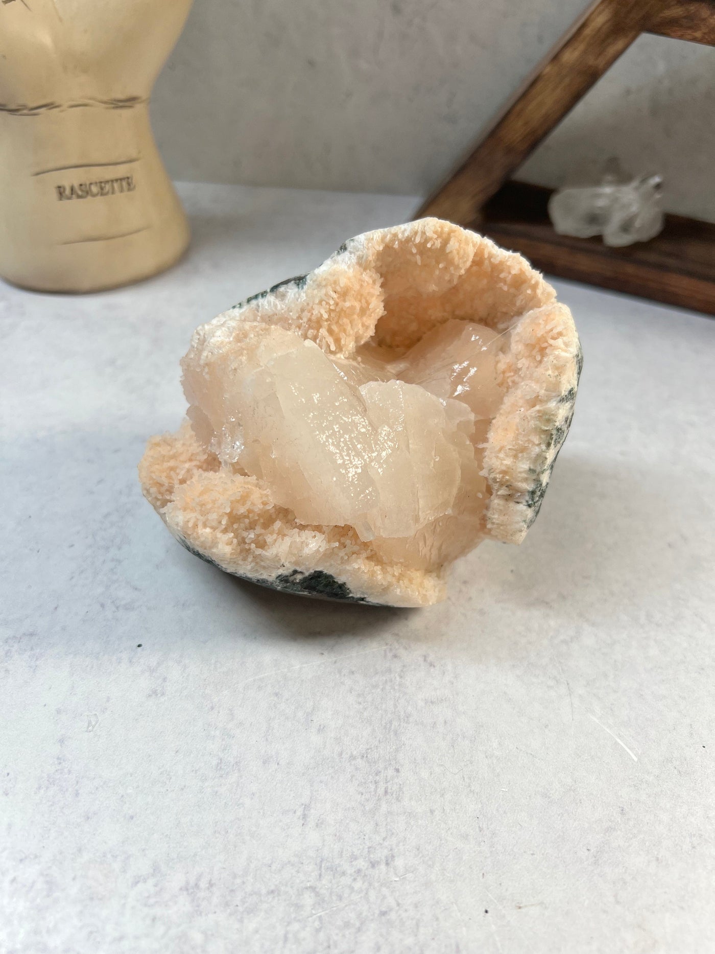 stilbite on matrix with decorations in the background