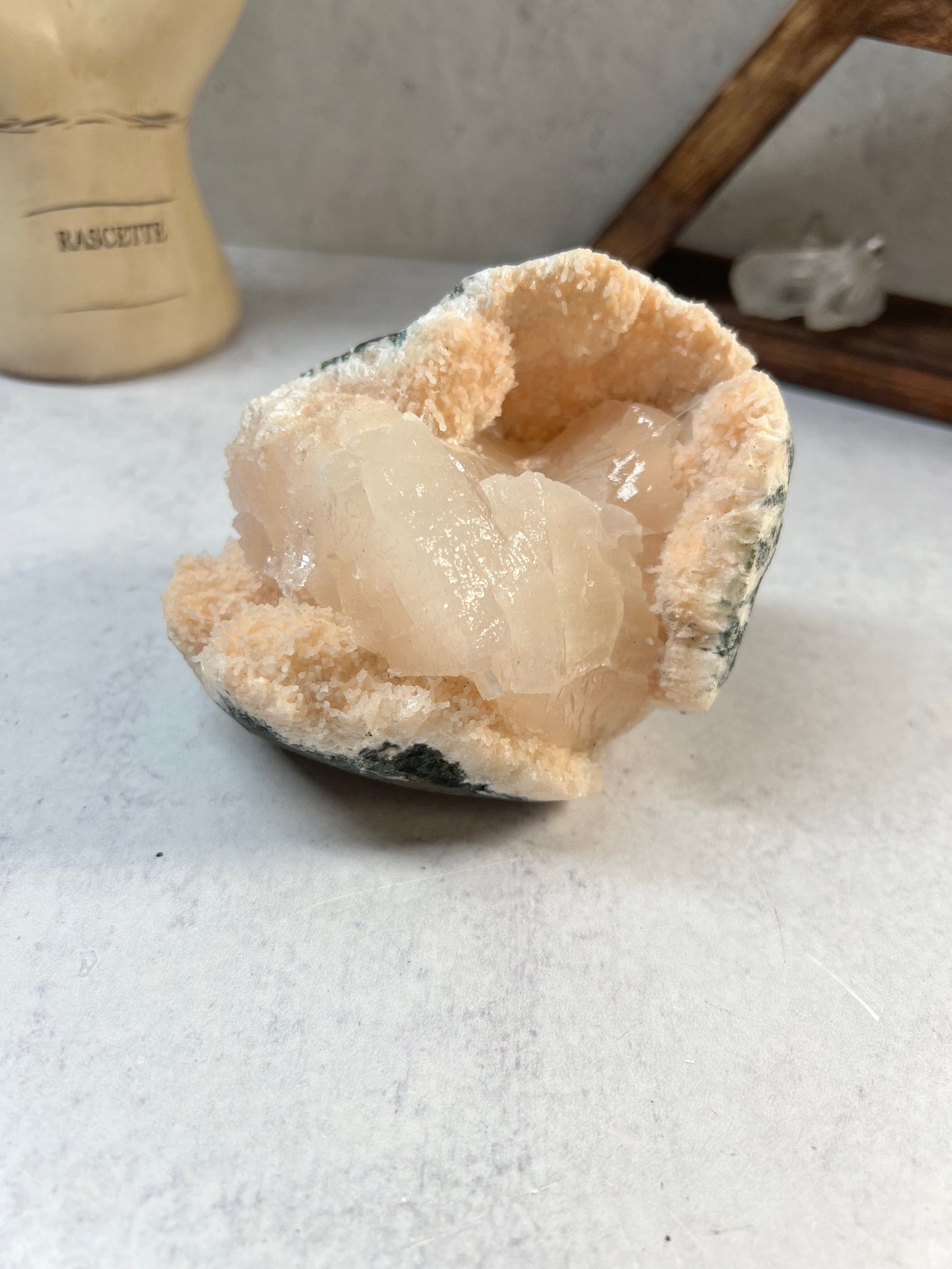 stilbite on matrix with decorations in the background