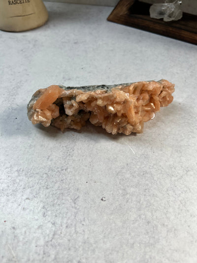 peach apophyllite with decorations in the background