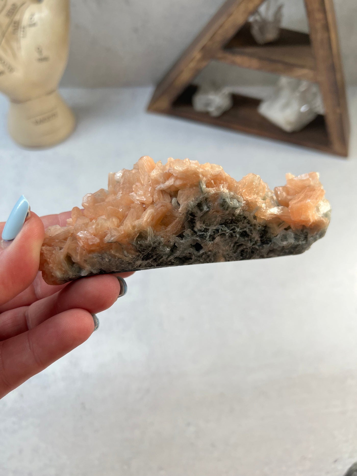 peach apophyllite with decorations in the background