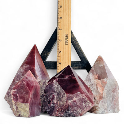 Guava Quartz Semi Polished Crystal Points with a ruler for size reference.