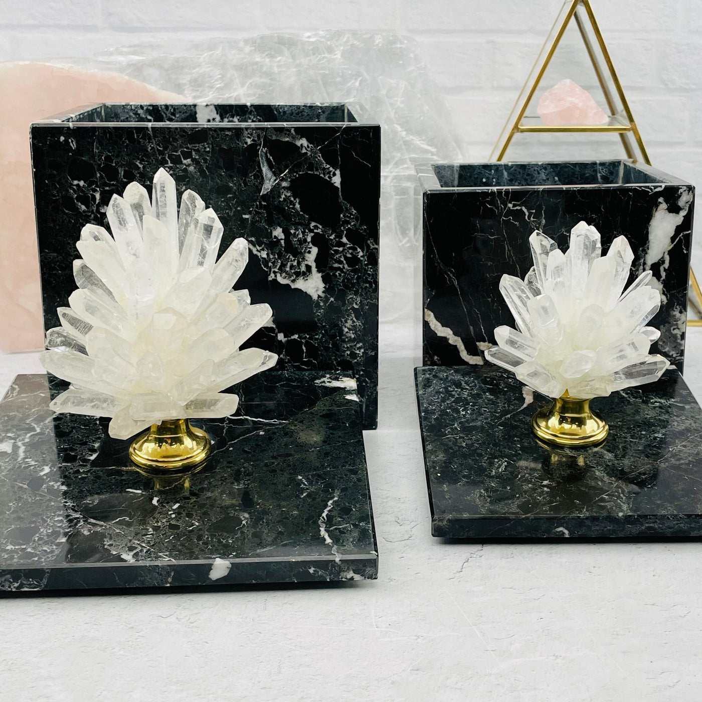  crystal point pinecone on marble box with lids off and decorations in the background