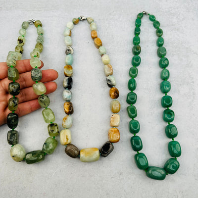 necklaces displayed to show the differences in the color shades and crystal types
