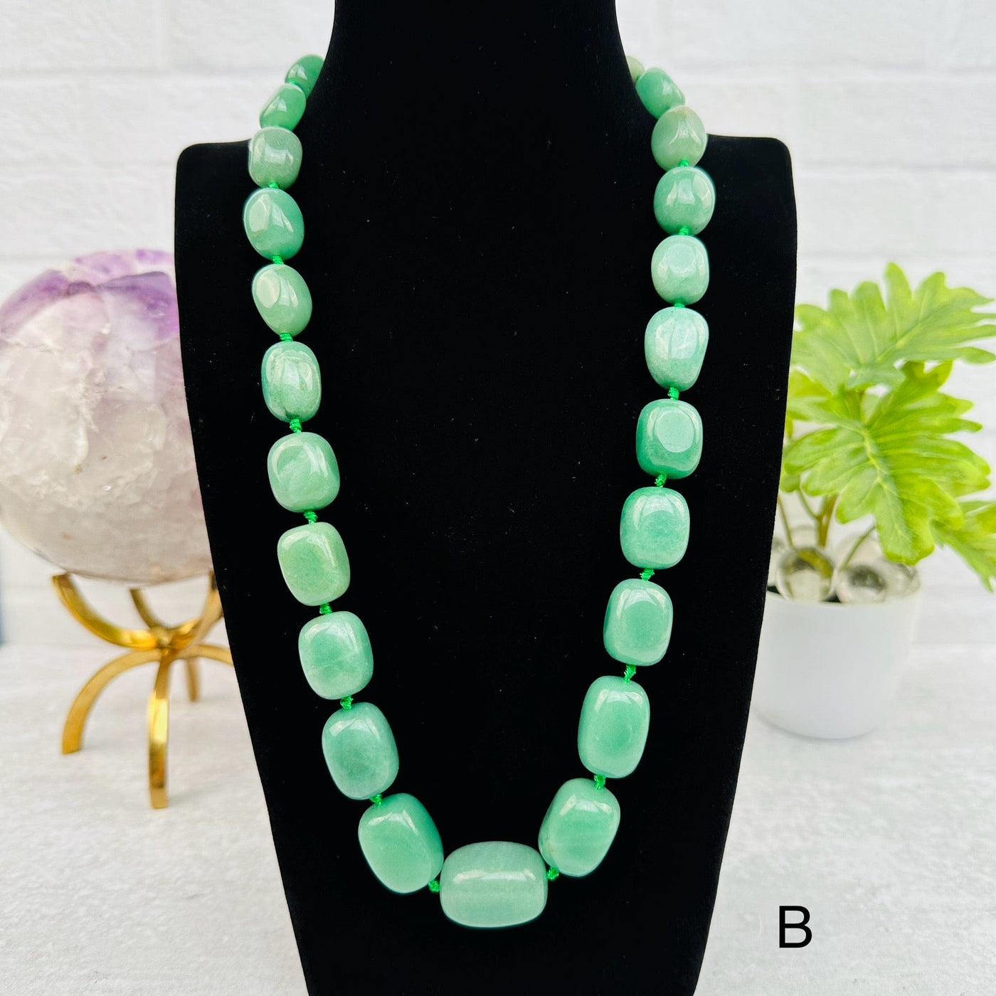 green aventurine necklace displayed to show how it hangs