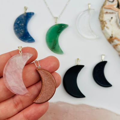 Crescent Moon Gemstone Pendant in hand for size reference 