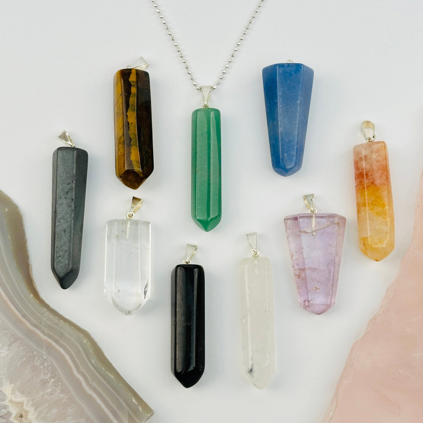 multiple pendants displayed to show the differences in the crystal types