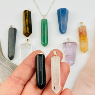 Gemstone Polished Point Pendants with Silver Toned Bail in hand for size reference 