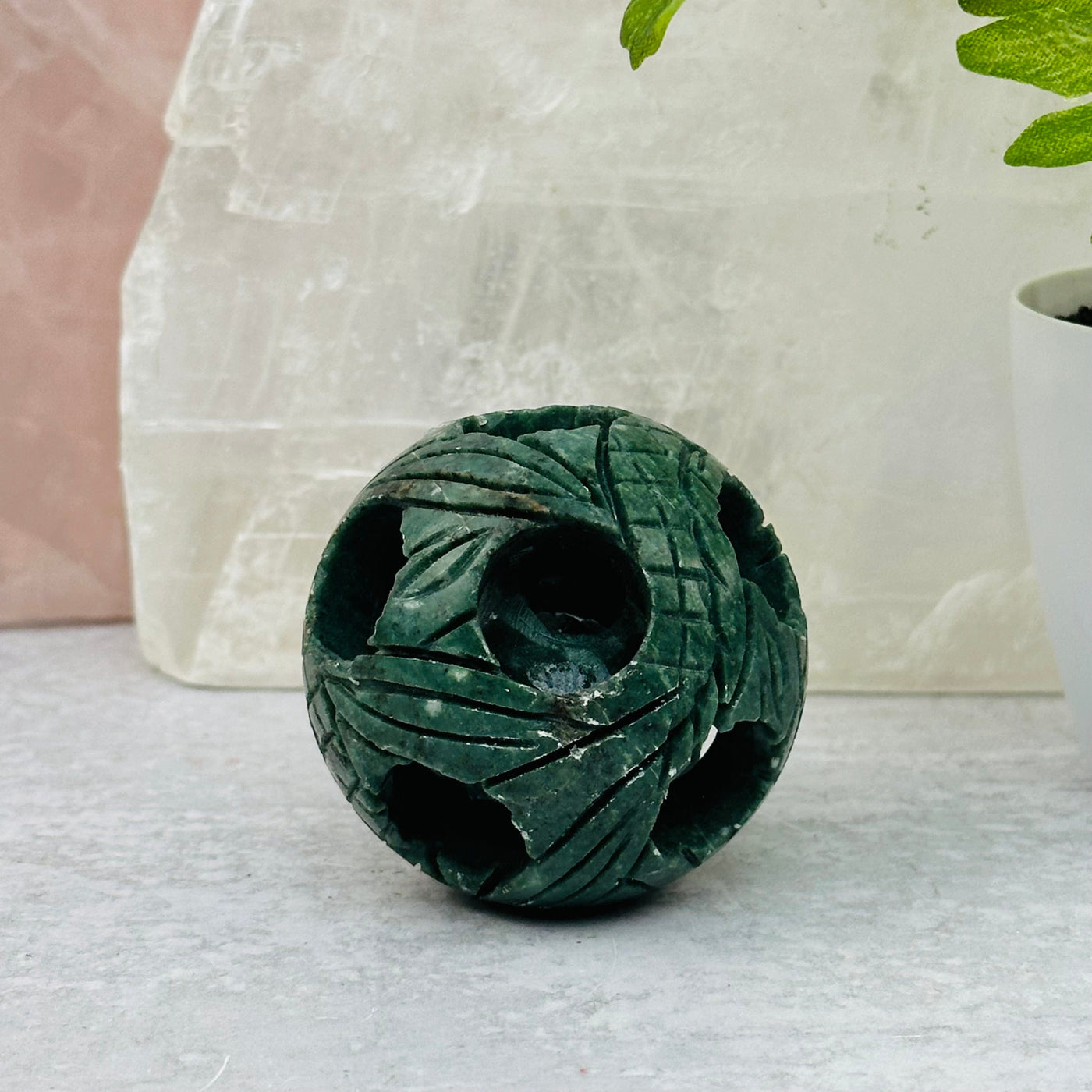 small Carved Jade Puzzle Ball displayed as home decor 