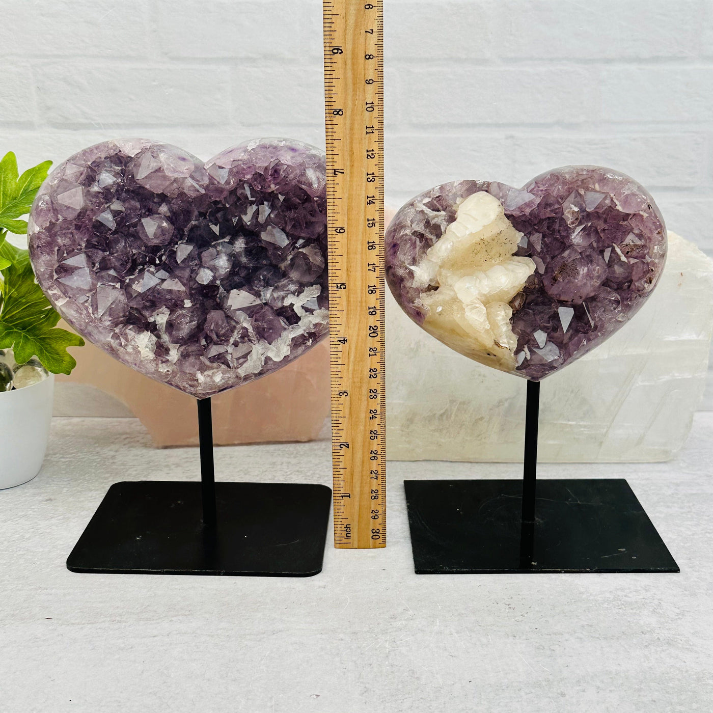 hearts on stand next to a ruler for size reference 