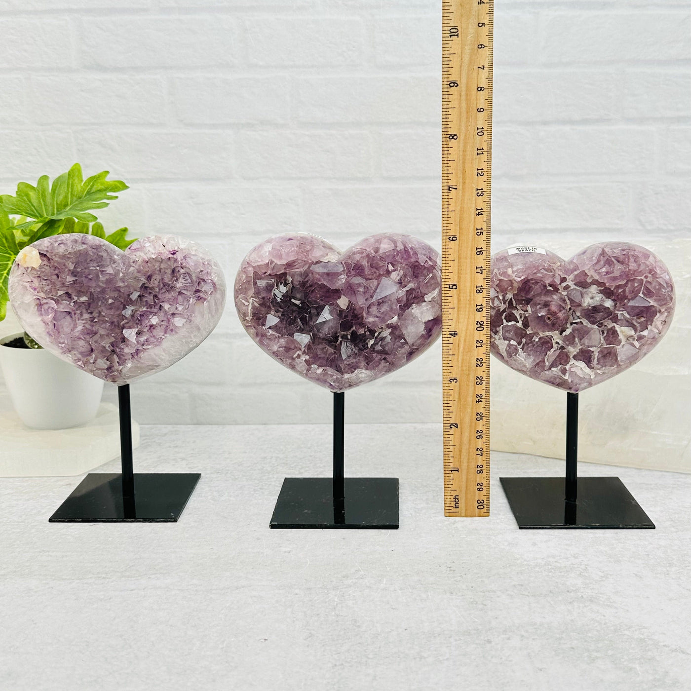 amethyst hearts next to a ruler for size reference 