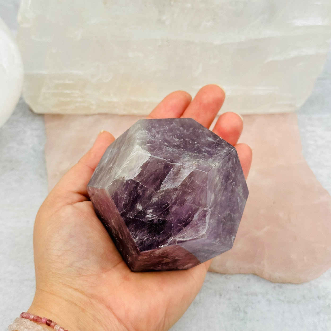 Amethyst Crystal Dodecahedron in hand for size reference 