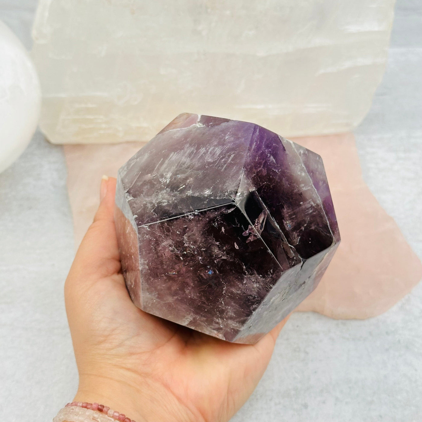 Amethyst Crystal Dodecahedron in hand for size reference 