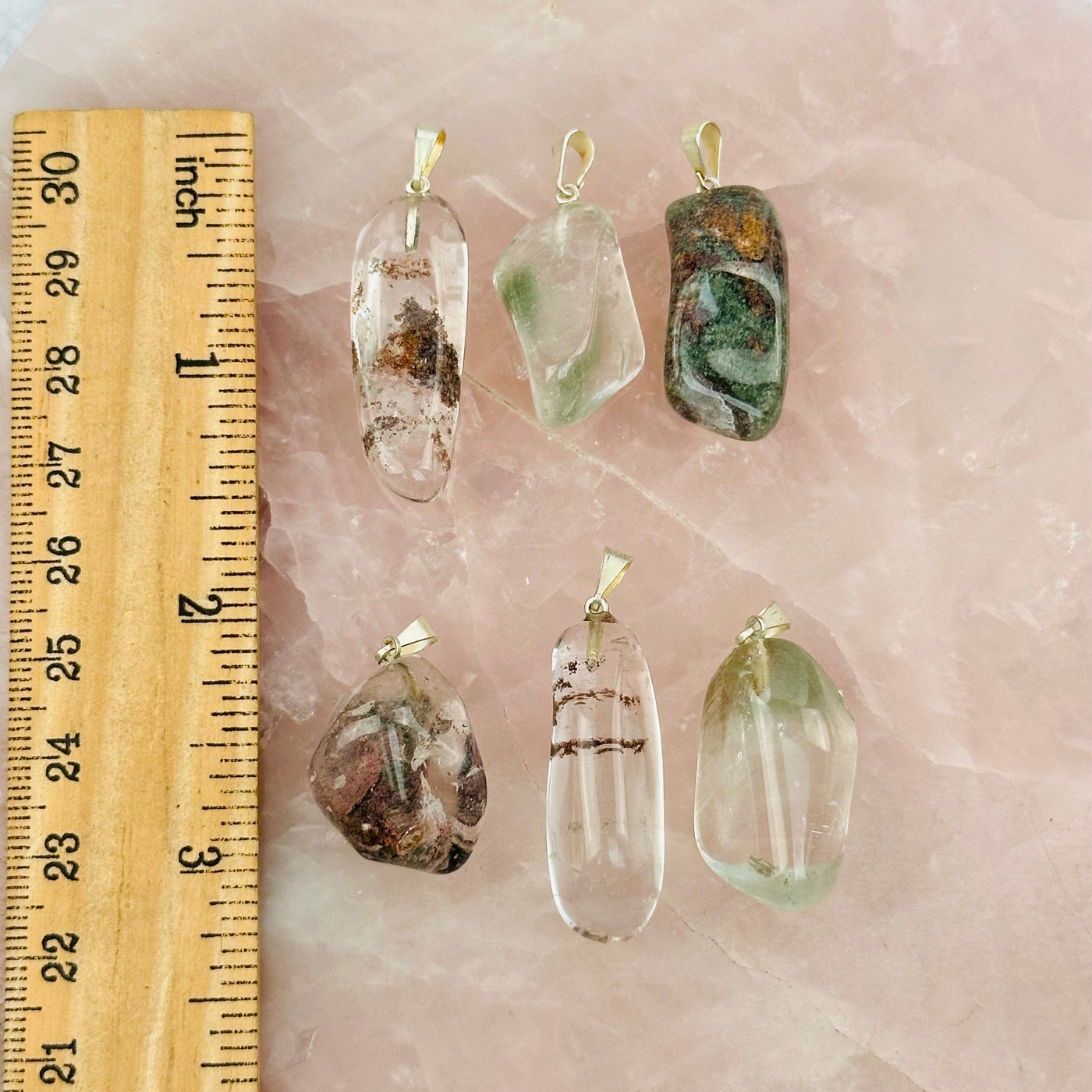lodolite pendants next to a ruler for size reference 