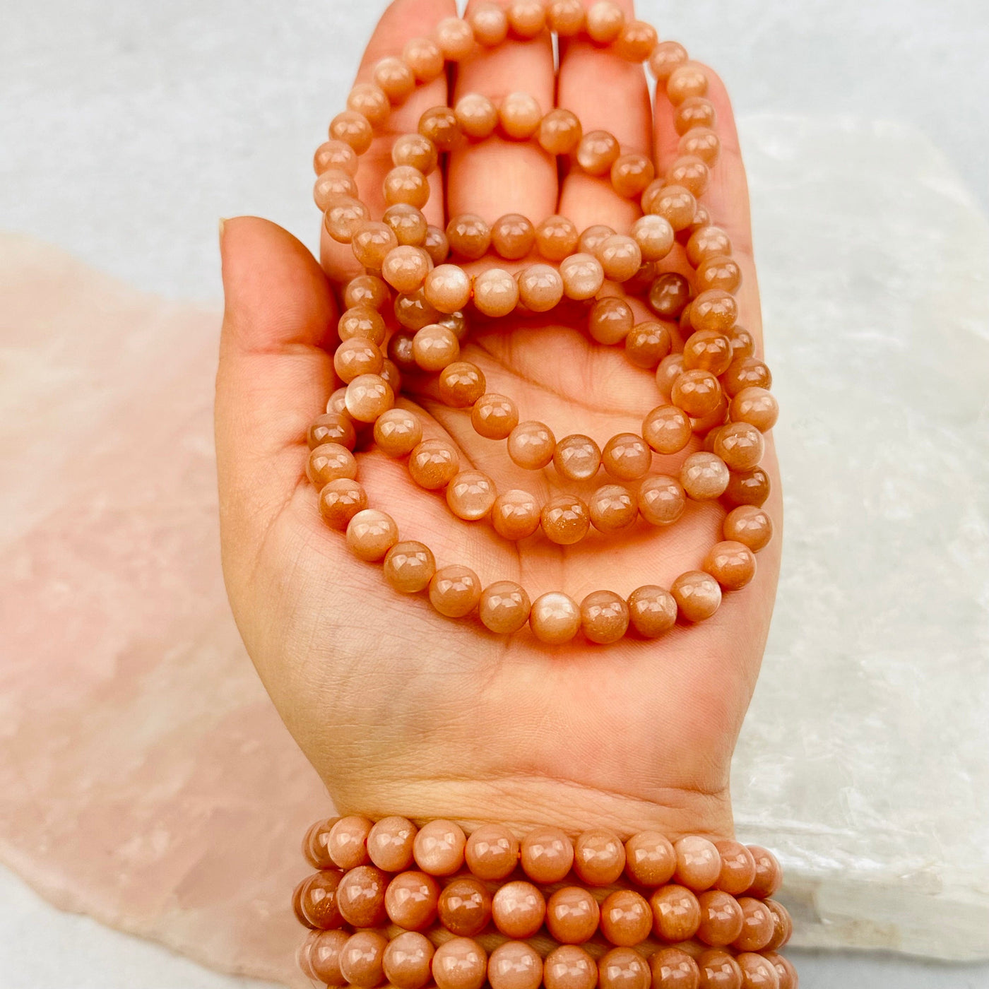 Peach Moonstone Round Bead Bracelets - 7mm - in hand for size reference 