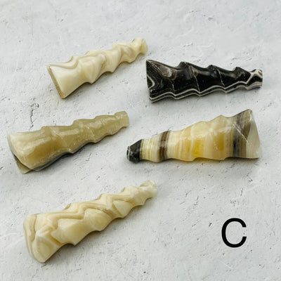 multiple onyx shaped shells displayed to show the differences in the color shades