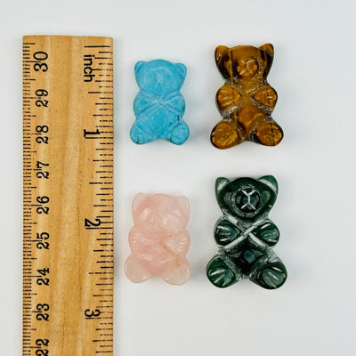 bear cabochons next to a ruler for size reference 