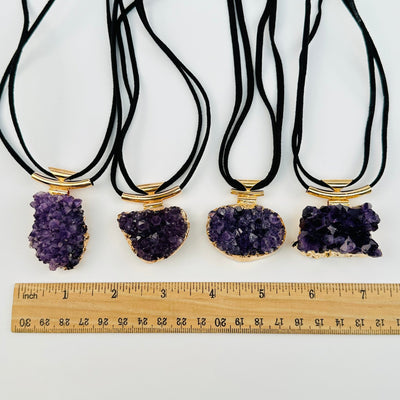 necklace clusters next to a ruler for size reference 