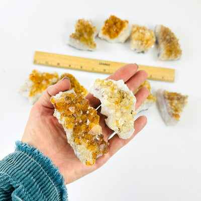 Citrine Crystal Clusters  with a couple in a hand for size reference