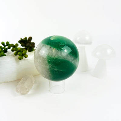 Green and White Quartz Crystal Sphere on display