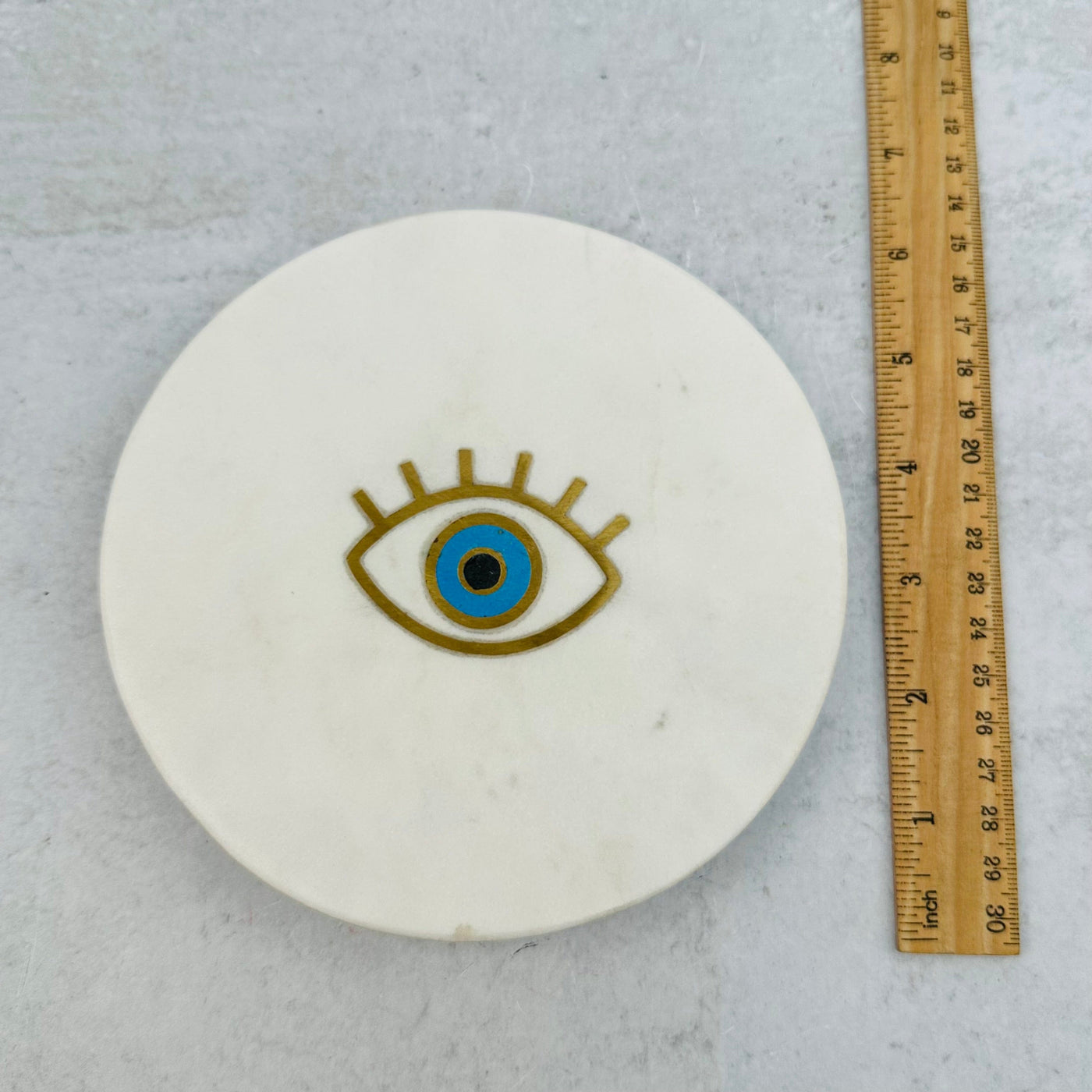 plate next to a ruler for size reference 