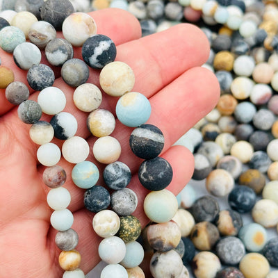 matte amazonite beads in hand for size reference 
