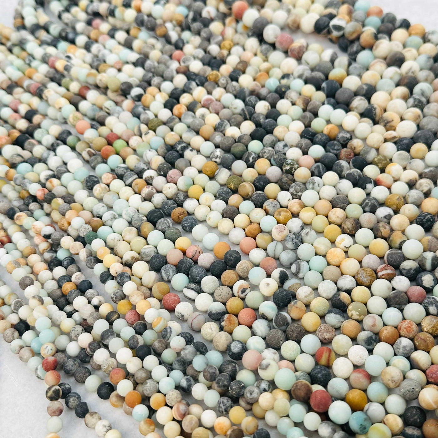multiple beads displayed to show the differences in the sizes and color shades 