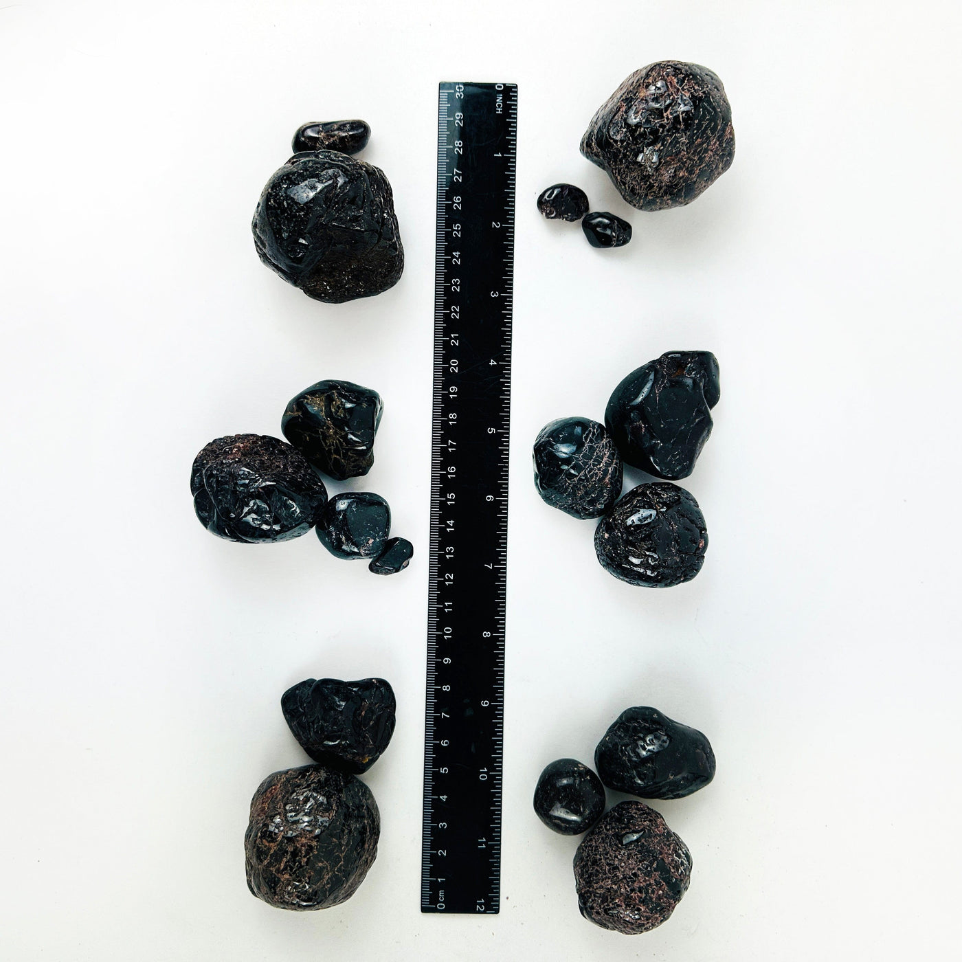 Tumbled Garnet Crystals next to a ruler for size reference