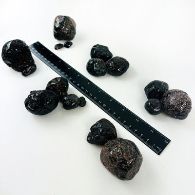 Tumbled Garnet Crystals next to a ruler from another angle