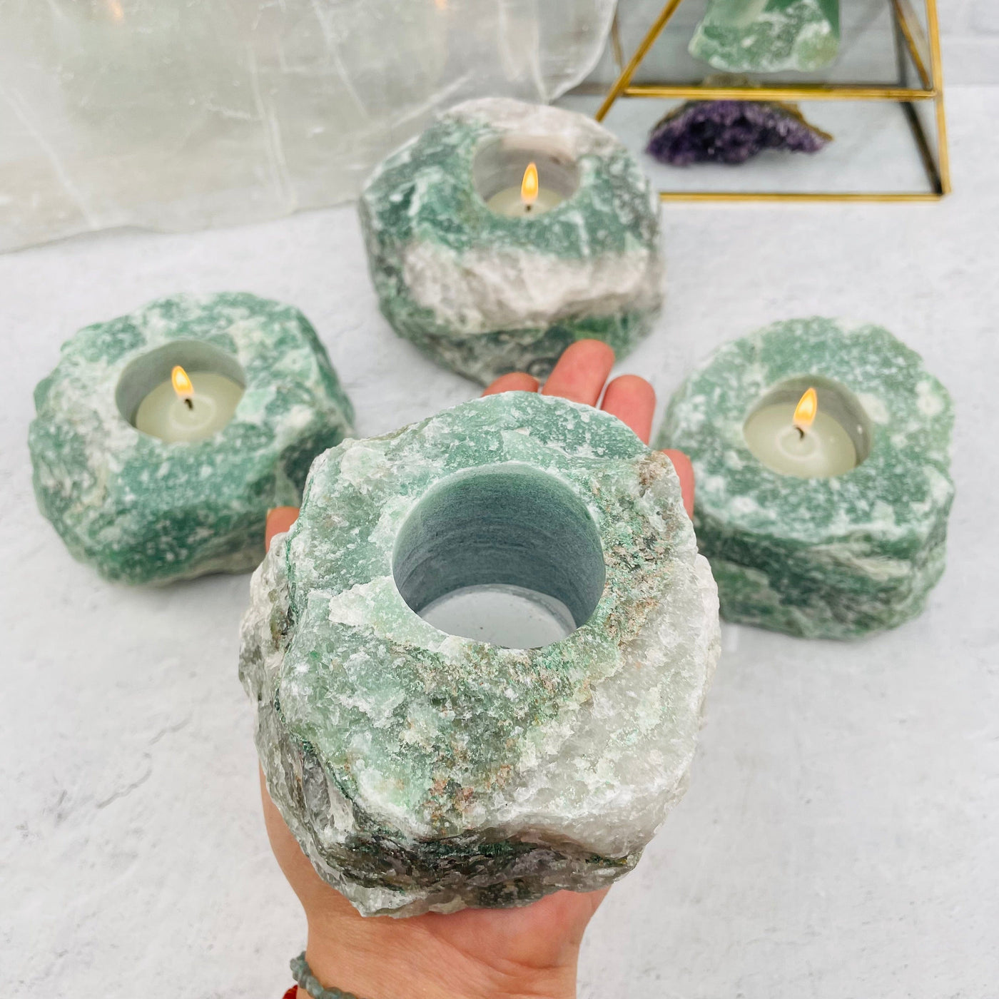 Green Quartz Candle Holder in hand for size reference 