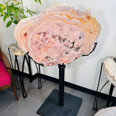 Semi-polished Pink Amethyst free form on custom Metal StandSemi-polished Pink Amethyst free form on custom Metal Stand displayed as home decor 