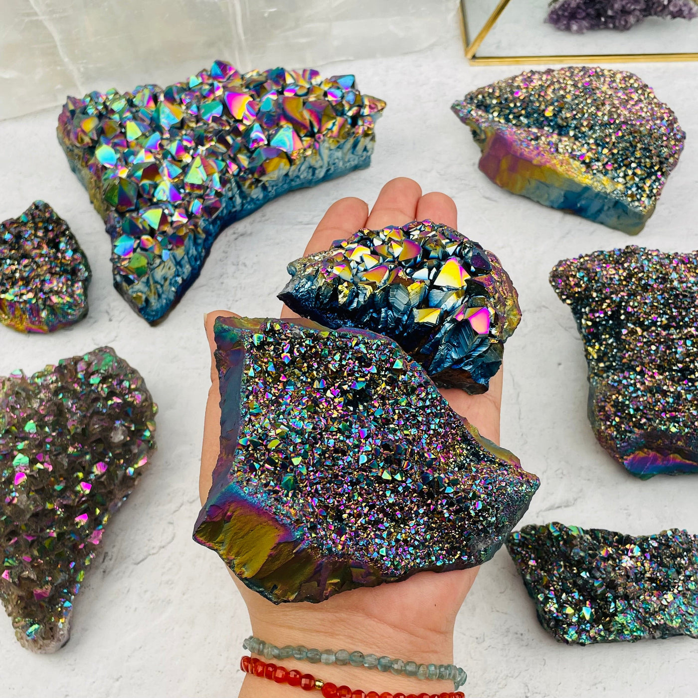 Amethyst Druzy Cluster with Rainbow Titanium Finish in hand for size reference 