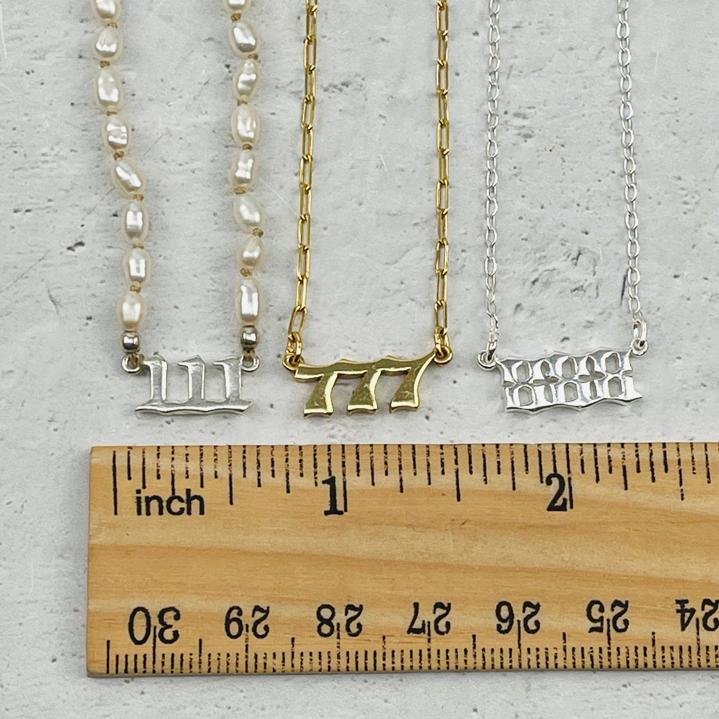 charms next to a ruler for size reference 