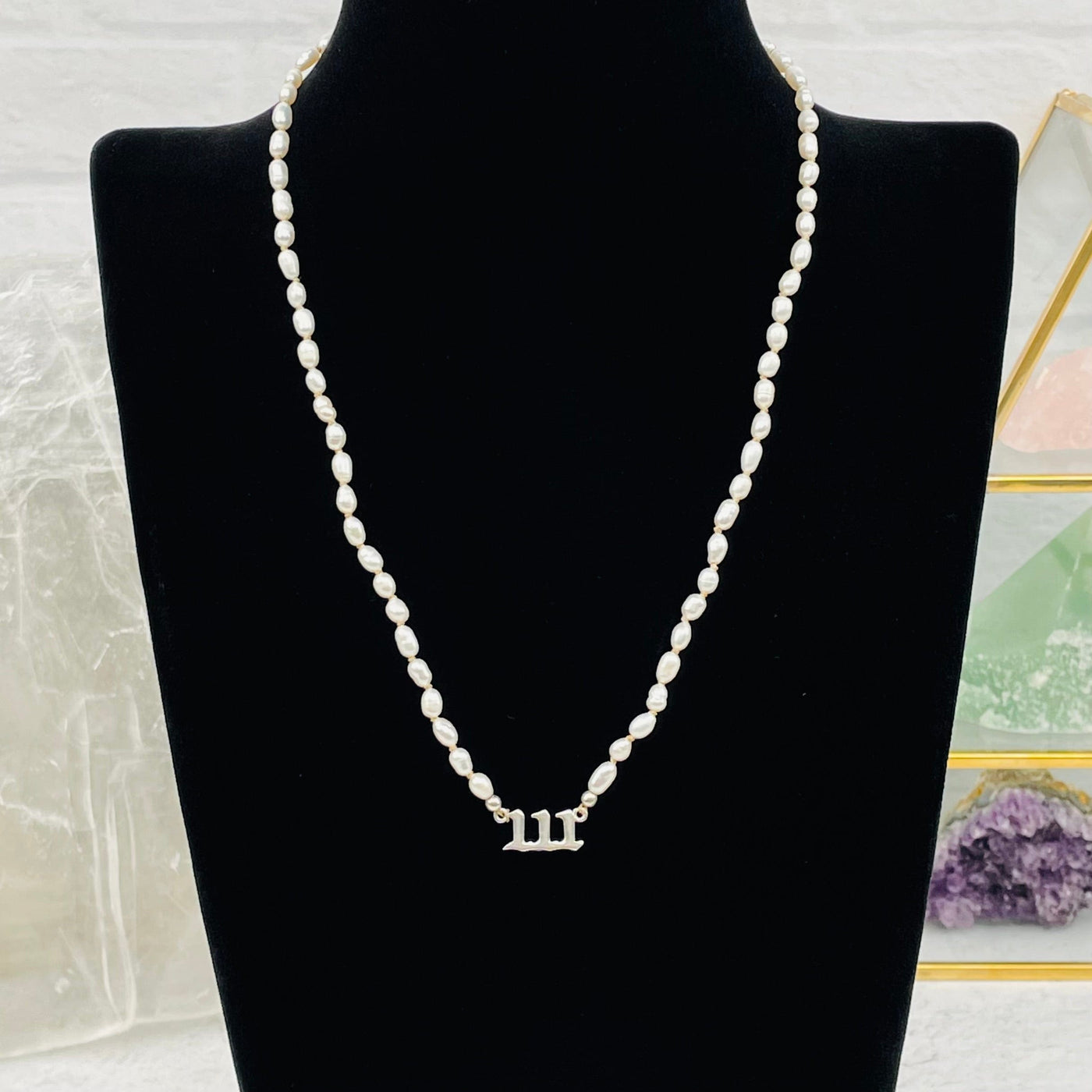 pearl number necklace displayed to show how it hangs 