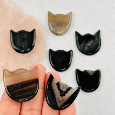 black agate cats in hand for size reference 