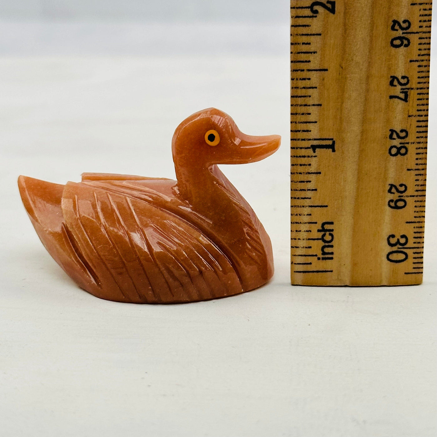 Carved Crystal Duck next to a ruler for size reference 