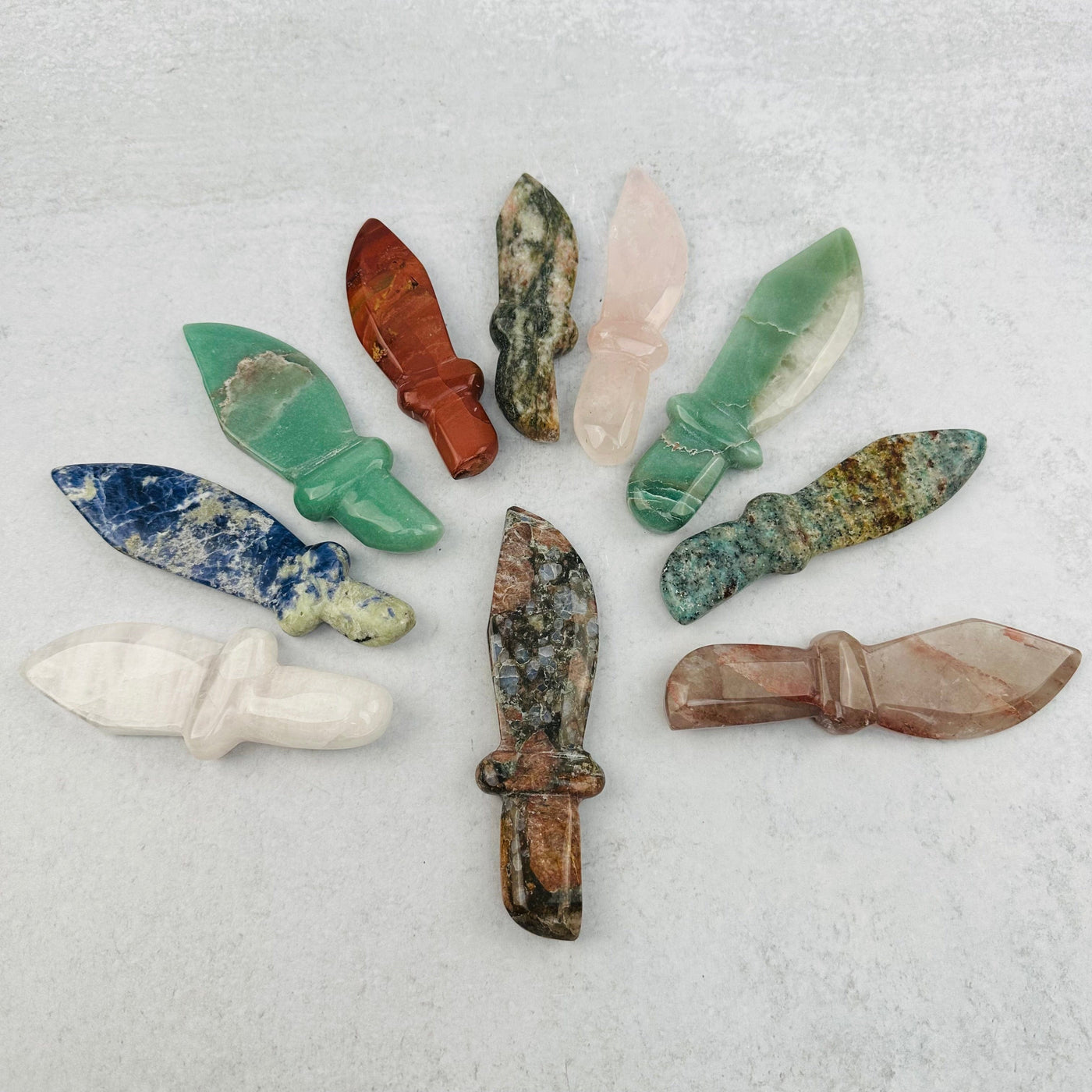 multiple gemstone knifes displayed to show the differences in the crystal type